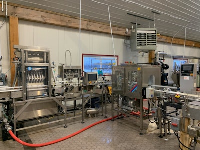 The filler is followed by a can rejector that will remove any cans missing lids, an air dryer, a checkweigher, and the tray packer. All sections assembled in house.