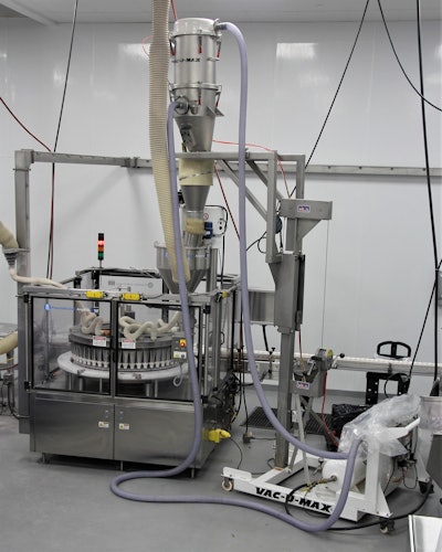 The vacuum receiver with integral mobile frame conveys material to a rotary filling machine at rates up to 3,500 lb/hr.