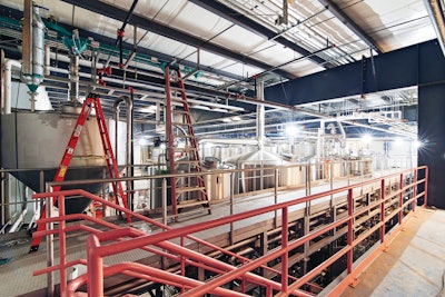 A mezzanine view of the 100-hL CombiCube brewhouse shows the included energy recovery system, which recovers steam energy from the boiling wort and gives it back as hot water to use for cleaning or the next batch of beer.
