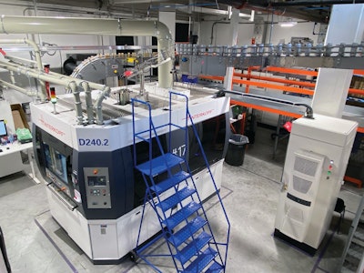 At Hart Print, cans enter the 16-station rotary printing system from above.