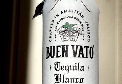 Paperboard bottles are formed around empty foil laminated pouches and sealed with adhesive prior to filling.