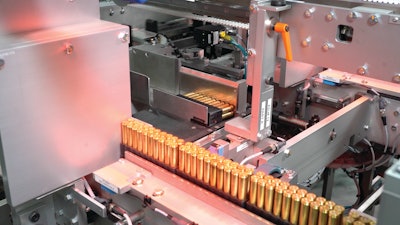 Trayed ammunition is laid prostrate for carton loading.