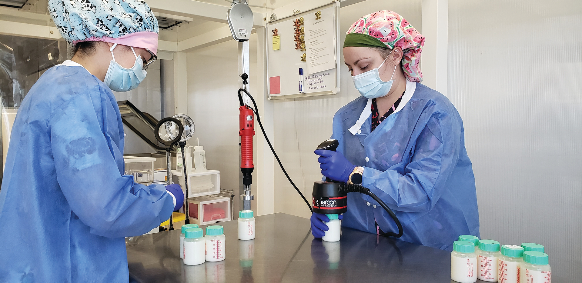 Operators at Mother&rsquo;s Milk Bank induction seal 100-mL rigid bottles prior to pasteurization.