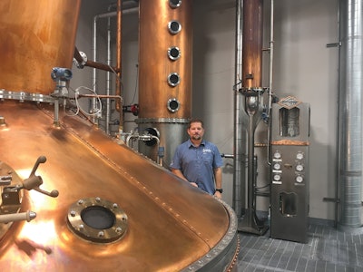 Head Distiller Greg Eidam stands next to the country’s largest pot still located in Kodak, Tenn. The pot still was designed to handle growing sales of Roaming Man Whiskey.