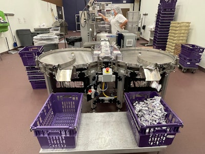 The new conveyor system includes two rotary tables instead of one. When configured to run the smaller Magic Morsels, the tables divert the treats past a photo eye to be counted and then down a chute to a waiting tote.