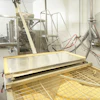The flexible screw conveyor transports cholestyramine resin, a difficult-to-move powder, to the pouch filling machine.