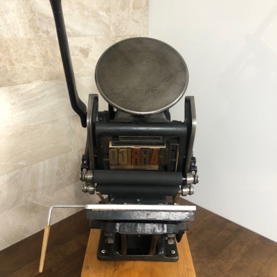 This antique printing press is on display in the skybox conference center as a reminder of the company history.