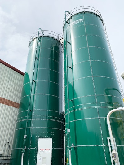 Two green silos store the woodchip mixture that is used as the ‘soil’ to grow mycelium.