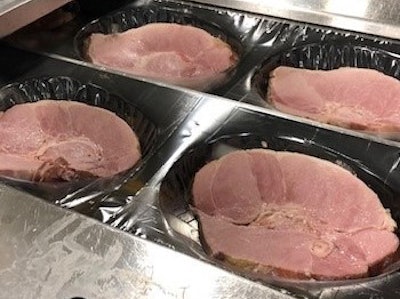 Once cut from the center of hams, steaks are placed in individual pockets. By installing cameras on the line, Smithfield Packaged Meats has been able to reduce its plastic/film waste by about 75%.