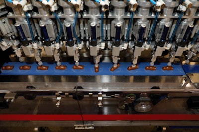 Carousel Feeding System For Flat Based Chocolate Pralines