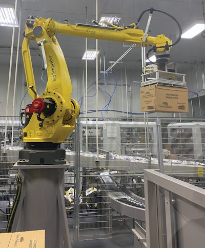 The robotic palletizer includes end-of-arm tooling with slip sheet pick-and-place capability.
