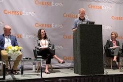 Panelists (from left) Sumeet Mathur, Josh Luth, Shaina Ashare, Michel Wattiaux (standing), Erica McDougall, Shane Reynolds, and Kyle Jensen discuss sustainability in the dairy industry during a discussion at CheeseExpo.