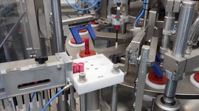 The brush and wand extend so far beyond the closure collar that, when the cap is closed over the tube just after filling, the brush is plunged deep into the product well under the closure.