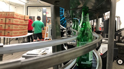 Returnable bottles of Sun Drop stay snugly on track with Multi-Conveyor’s tabletop system.