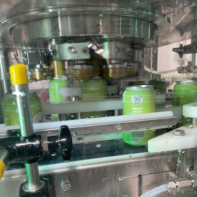 PSA is known for seaming. Here, a three-head seamer spins lids onto cans.