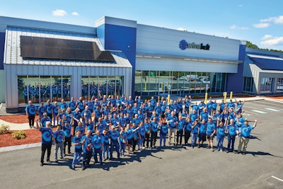 Wire Belt employees gathered outside the refurbished Walmart, which now serves as the company's new headquarters.