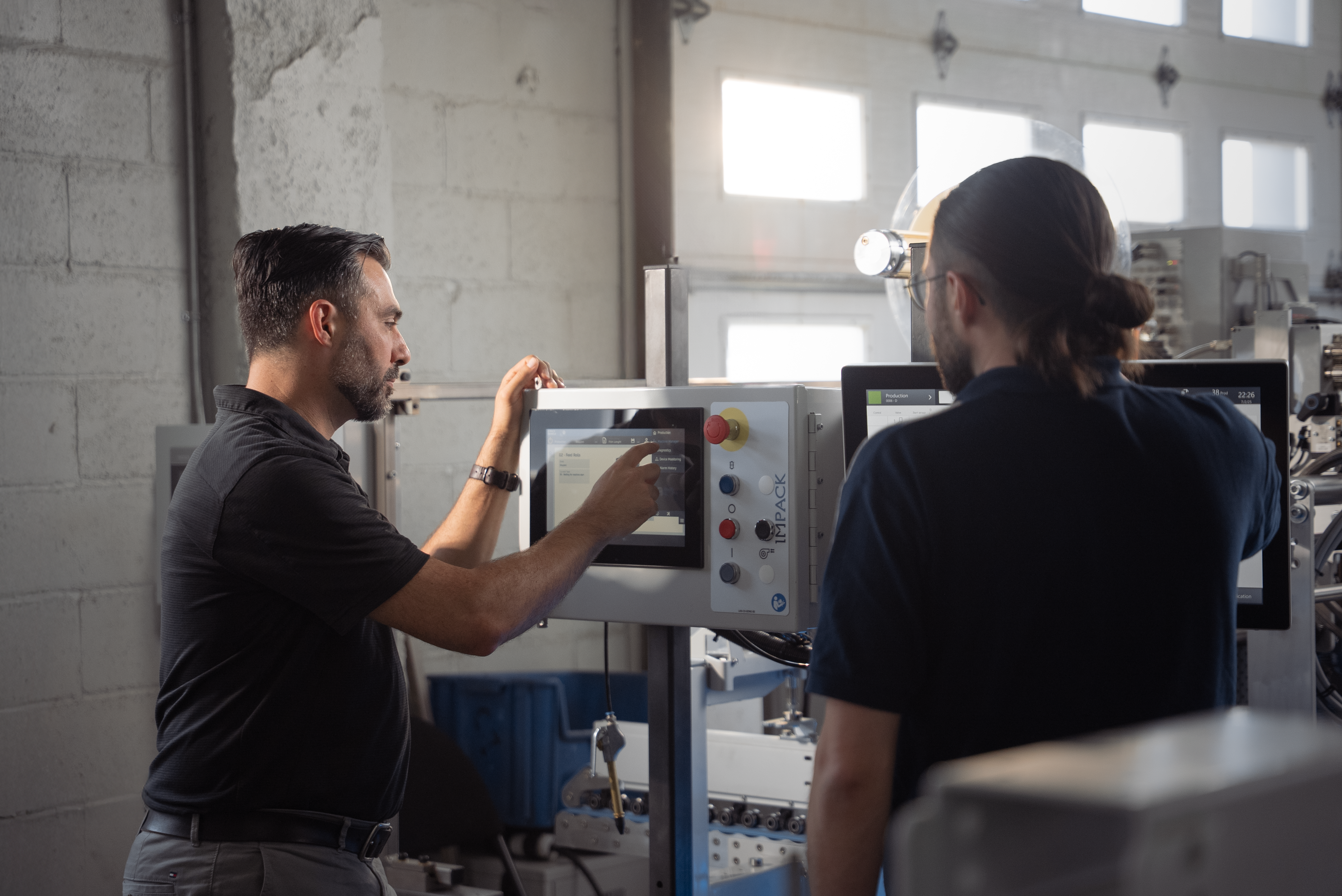 Fr&eacute;d&eacute;ric Boyadjian, head of automation, and C&eacute;dric Gaudreault, automation designer, fine-tune the settings of Impack&rsquo;s new automation app on a GenieCut.