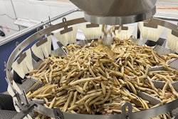 This 14-head combination scale drops 5-lb portions of Frozen French fries into a vertical form/fill/seal system below.