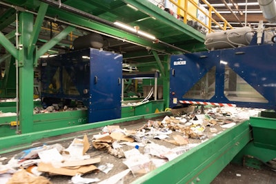 A stream of recycled waste, mostly packaging, enters Glacier's AI-supported robotic sortation equipment.