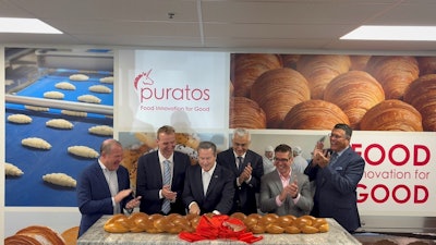 U.S. Congressman Donald Norcross (D-N.J.) cuts giant glazed challah bread to celebrate the opening of Puratos' new UHT bakery glaze facility.