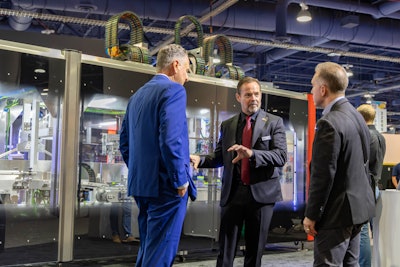 SOMIC Packaging’s CEO Peter Fox (center), said the number of people who expressed interest in the new 434 SuperFlex exceeded expectations.