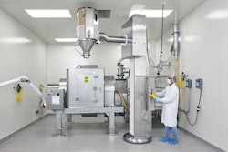 Drums containing each ingredient are lifted, aligned with the mixer's stationary inlet, and emptied—in a prescribed order according to the Master Batch Record.