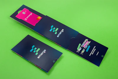 Burgopak designed a dual-slide mailer for fintech startup Emerge’s bank card, using 300 GSM artboard with holographic foil and spot UV to create an interactive unboxing experience.