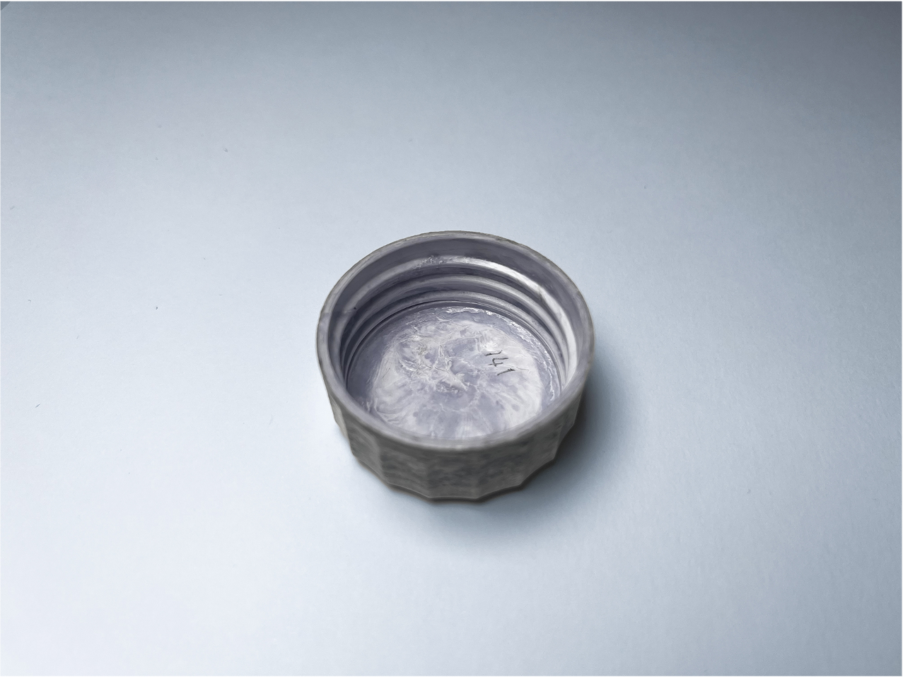 Advanced fiber cap sample approaching plastic-like performance and feel.