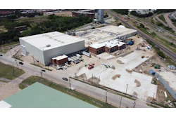 Site constraints include active rail lines that made construction challenging and define the site's footprint.