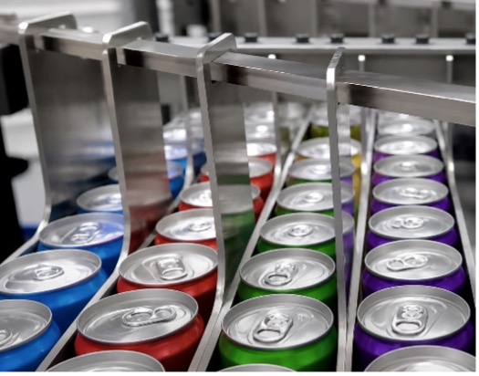 Colorful beverage cans arranged in rows on a production line with blue, red, green, and purple colored containers