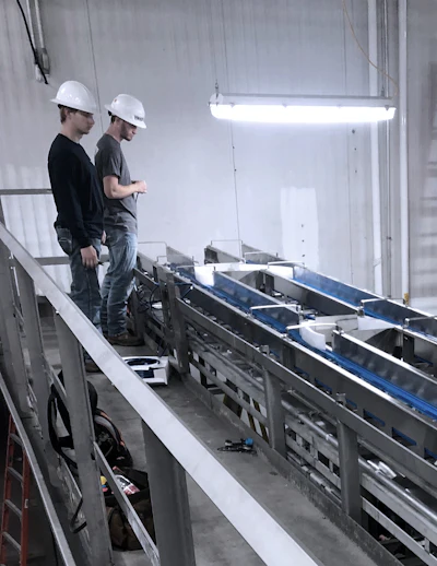 ProFab technicians oversee equipment installation.
