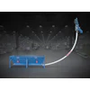 Industrial dust collection system with blue workstation table and overhead pneumatic arm in warehouse facility