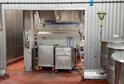 Industrial food processing equipment with stainless steel components in a warehouse facility