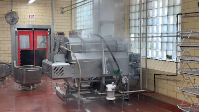 Industrial kitchen facility with large commercial cooking equipment and machinery in a warehouse space