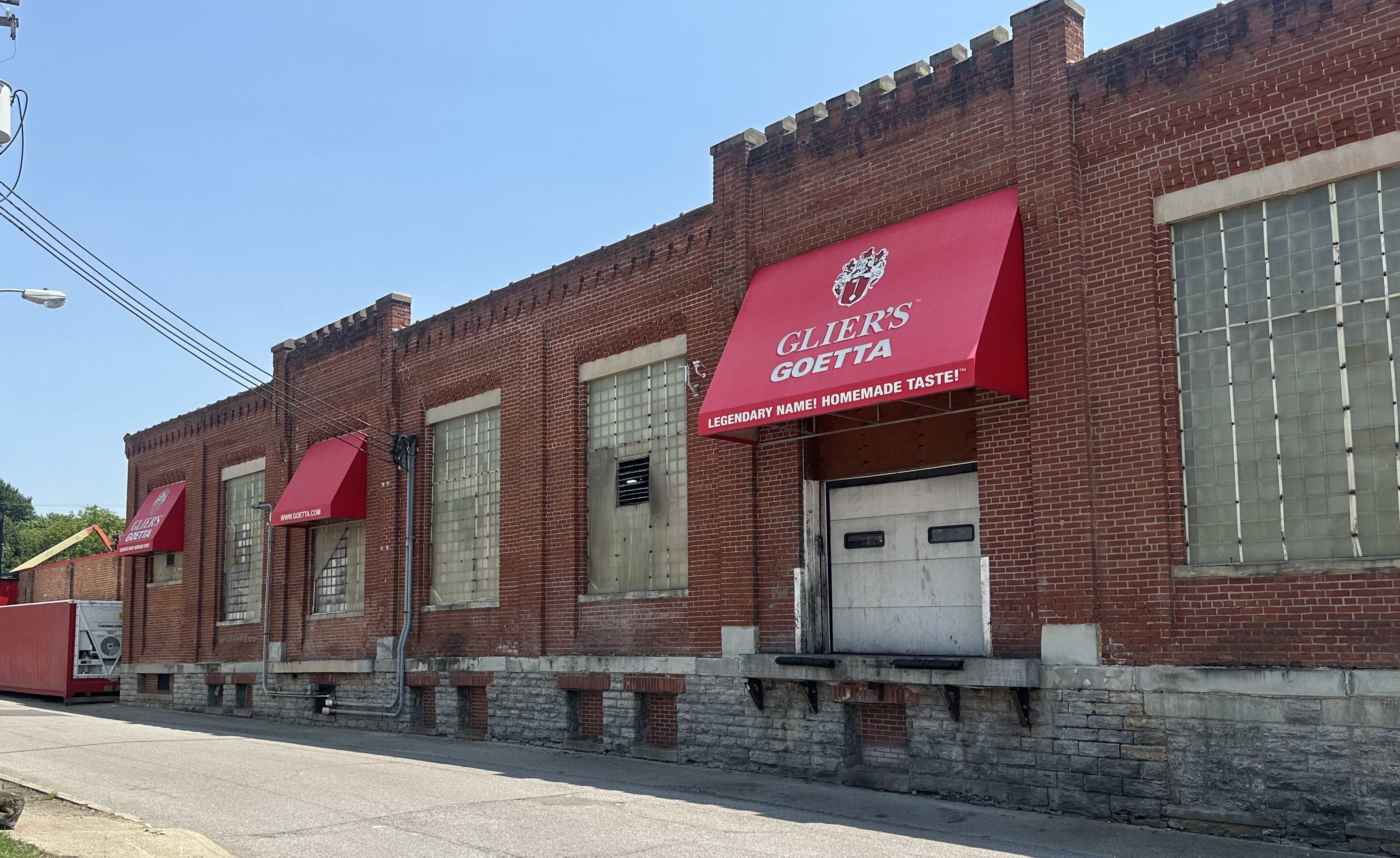 Historic brick storefront with red awnings displaying Guida's Guetta branding and 'Everybody Makes Homemade Taste' tagline