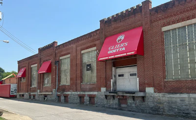 Historic brick storefront with red awnings displaying Guida's Guetta branding and 'Everybody Makes Homemade Taste' tagline