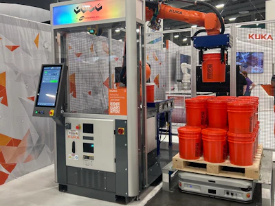 KUKA industrial robotics exhibition booth with automated arm system and red industrial containers on display