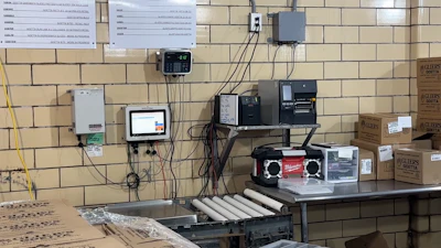 Industrial control panel and electronic equipment mounted on brick wall with wiring and devices