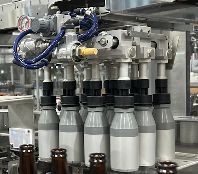 Robotic tooling that would be used if 21-oz bottles were in production. 12-oz bottles were on the line at the time of PW's visit.