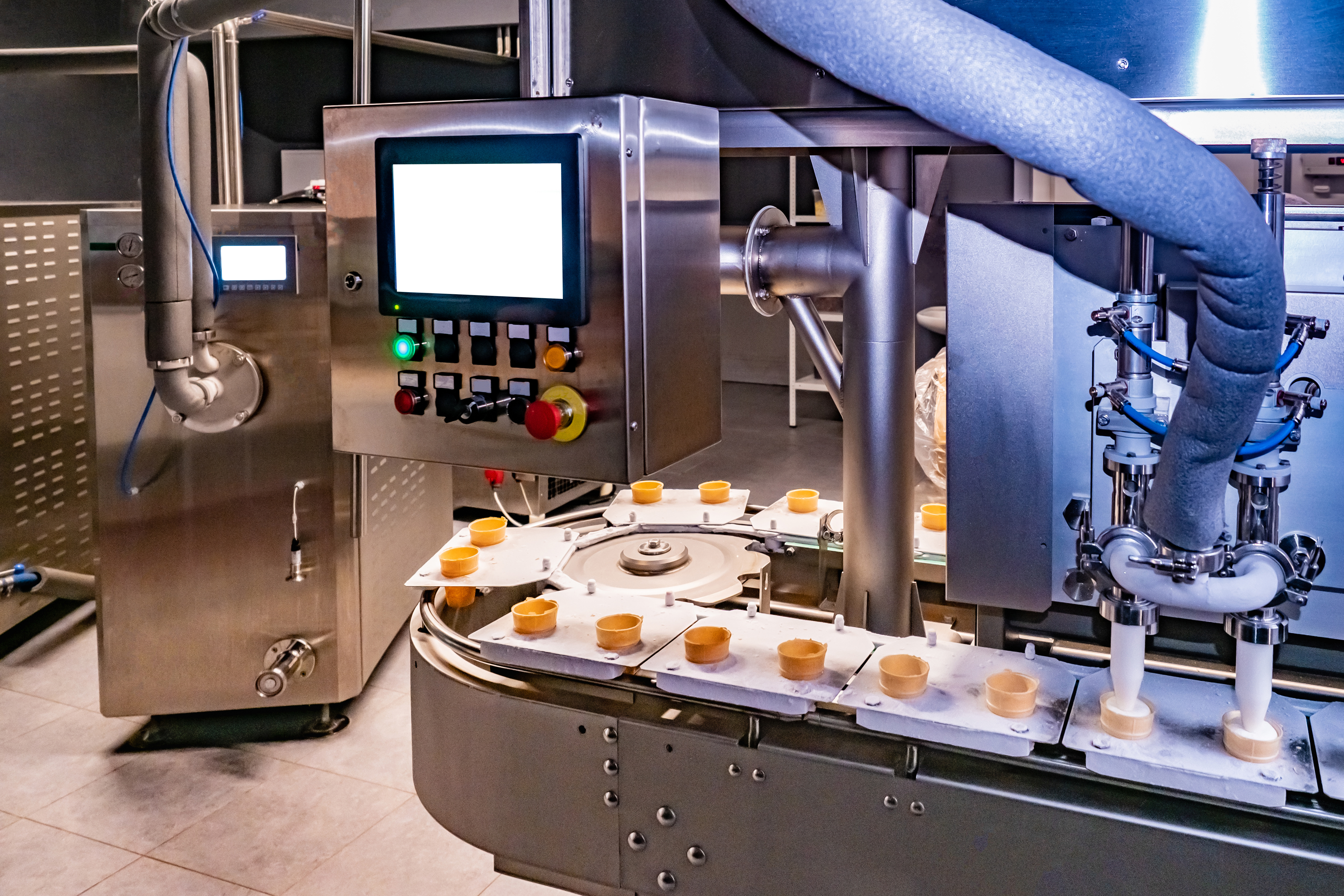 Industrial food processing machine with control panel dispensing product onto circular conveyor system