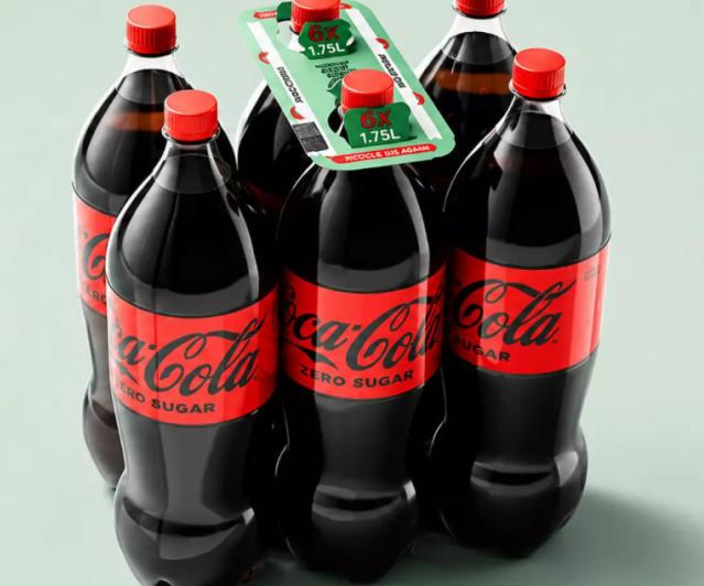 Four Coca-Cola Zero Sugar bottles with red caps arranged with green promotional packaging displaying 1.75L volume