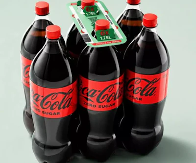 Four Coca-Cola Zero Sugar bottles with red caps arranged with green promotional packaging displaying 1.75L volume