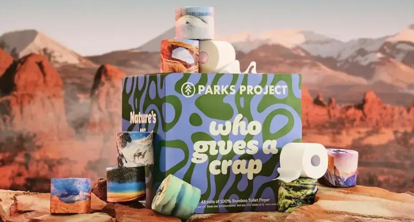 Parks Project bamboo toilet paper rolls displayed with colorful packaging in desert landscape setting
