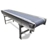 Industrial conveyor belt system with metal frame and blue textured surface on white background