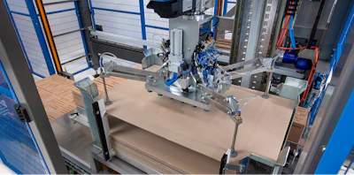 Industrial 3D printer with blue safety enclosure and mechanical components on work platform