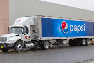 White Pepsi delivery truck with blue branded trailer parked against building