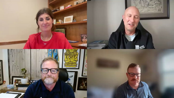 Four people in a video conference call displayed in a grid layout on screen
