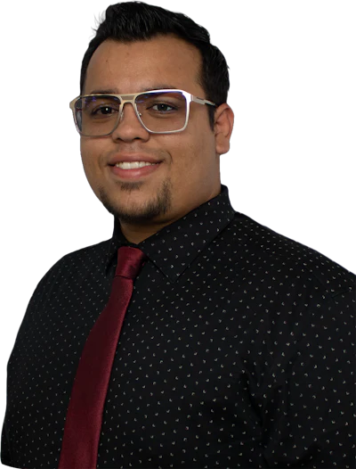 Professional headshot of a smiling man wearing glasses, black patterned shirt, and burgundy tie against white background