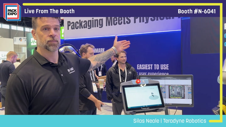 Presenter demonstrates Teradyne Robotics packaging solution at Pack Expo booth N-6041 with computer displays showing software interface