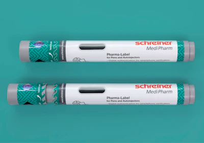 Two Schreiner MediPharm Pharma-Label tubes for pens and autoinjectors with green patterned sleeves on turquoise background